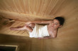 Woman relaxing in sauna