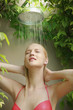 Woman showering herself at pool shower