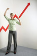 Foto: Businesswoman shaking fist in victory, arrow sign going up Businesswoman shaking fist in victory, arrow sign going up