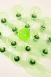 Green lightbulb among other lightbulbs