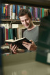 Man reading a book in the library