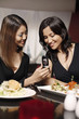 Woman showing her friend a text message