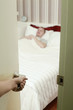 Man sleeping in bed, hand opening door