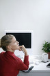 Foto: Businesswoman thinking while writing organizer Businesswoman thinking while writing organizer
