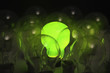 Green lightbulb among other lightbulbs