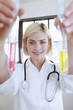 Doctor holding test tubes with liquid