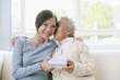 Senior woman kissing woman on the cheek