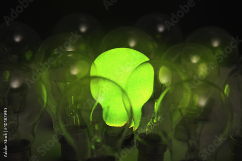 Photo: Green lightbulb among other lightbulbs Green lightbulb among other lightbulbs