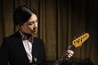 Young woman playing electric guitar