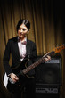 Young woman playing electric guitar