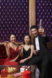Foto: Man and women holding up glass with liquor Man and women holding up glass with liquor