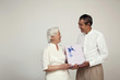 Senior woman receiving gift from senior man