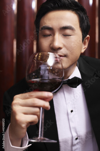 Photo: Man in tuxedo enjoying wine Man in tuxedo enjoying wine