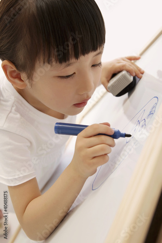 Photo: Girl drawing on whiteboard Girl drawing on whiteboard
