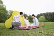 Girl feeding man with biscuit, woman watching