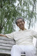Foto: Senior man laughing while sitting on a swing Senior man laughing while sitting on a swing