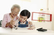 Foto: Senior woman teaching boy calligraphy Senior woman teaching boy calligraphy