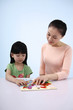 Woman teaching girl about places from the map