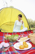 Woman sitting in the tent holding a glass of milk