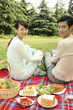 Man and woman having picnic in the park