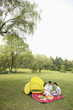 Girl and parents having a picnic in the park