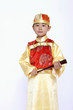 Boy in traditional costume with a hand-held fan
