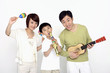 Boy playing musical instrument with his parents