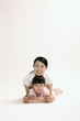 Woman and girl lying forward smiling