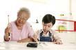 Foto: Senior woman and boy writing calligraphy Senior woman and boy writing calligraphy