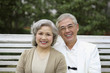 Foto: Senior man and senior woman posing on the swing Senior man and senior woman posing on the swing