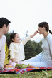 Photo: Girl feeding woman with strawberry, man watching Girl feeding woman with strawberry, man watching