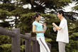 Man and woman chatting while holding water bottles