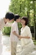 Boy kissing woman, man smiling while watching