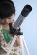 Girl looking through telescope
