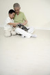 Senior man and boy playing with dog