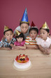 Photo: Woman and children blowing birthday candles together Woman and children blowing birthday candles together