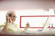 Photo: Senior woman talking on the phone while holding credit card Senior woman talking on the phone while holding credit card