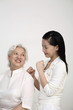 Woman massaging senior woman's back