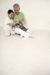 Senior man and boy playing with dog