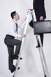Businessmen climbing the corporate ladder