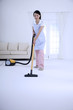 Woman vacuuming the floor