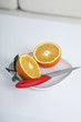 Photo: Two halved oranges and knife on a plate Two halved oranges and knife on a plate