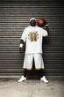 Man holding basketball posing for the camera