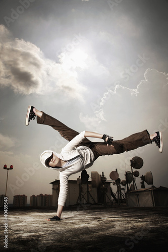 Photo: Young woman making a breakdance move Young woman making a breakdance move