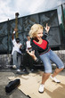 Woman dancing while two men watches her