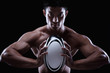 Photo: Man holding rugby ball Man holding rugby ball