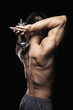 Muscular man lifting dumbbell