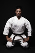 Man in karate uniform kneeling down