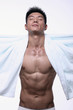 Photo: Man with towel around his neck closing eyes Man with towel around his neck closing eyes