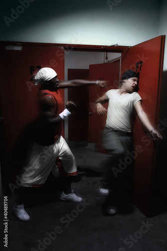 Photo: Man punching another man in the face Man punching another man in the face